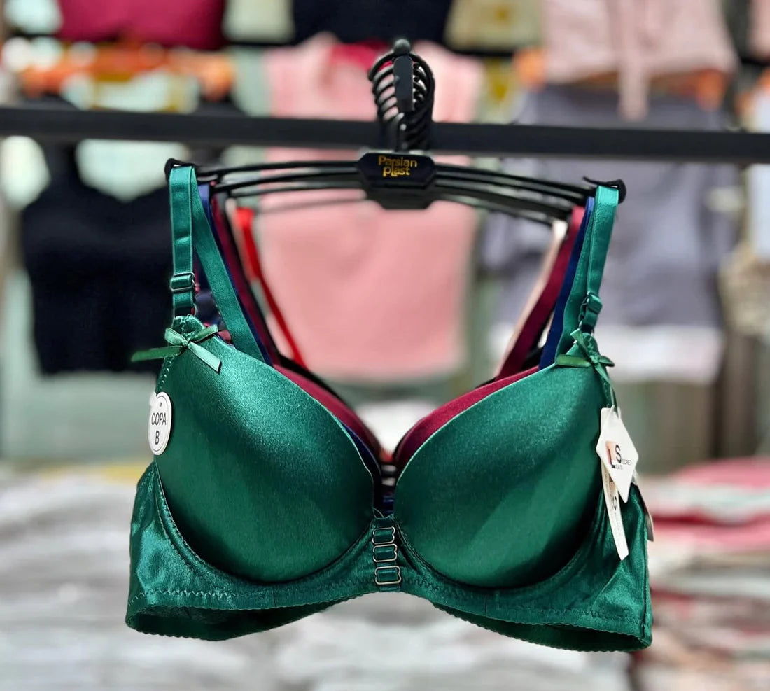 Green bra on a hanger with a blurred background