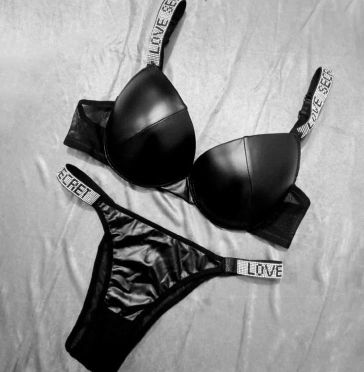 Black lingerie set with 'LOVE' label on a light gray background