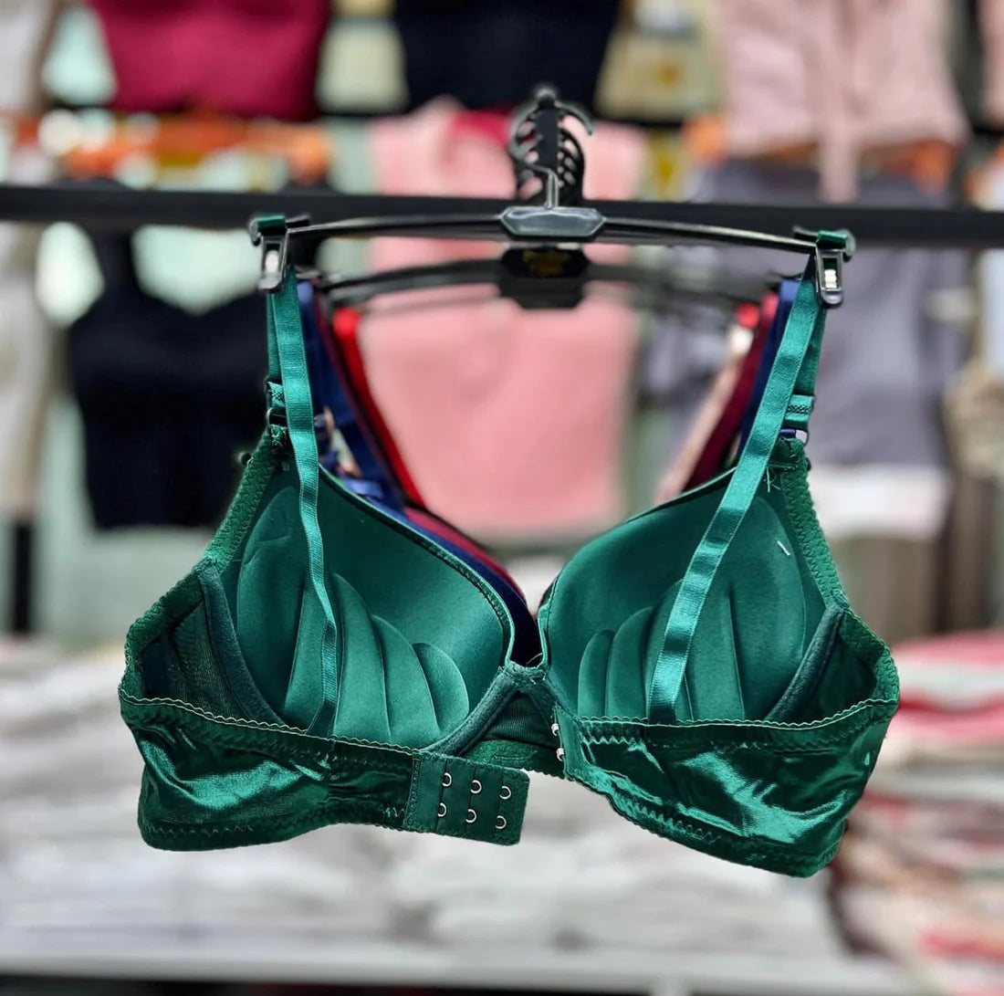 Green bra on a hanger with a blurred background