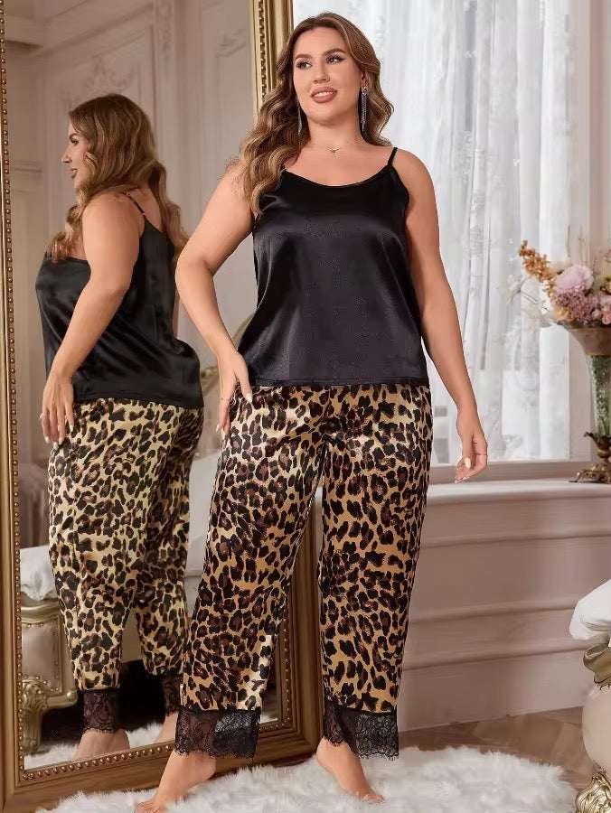 Woman wearing a black top and leopard print pants standing in front of a mirror.