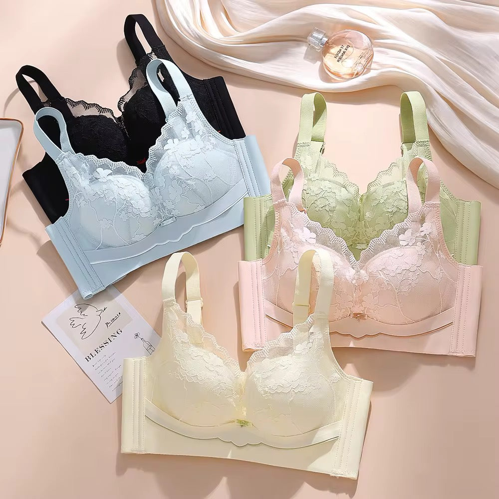 Three bras in black, green, and beige on a pink background with a perfume bottle.