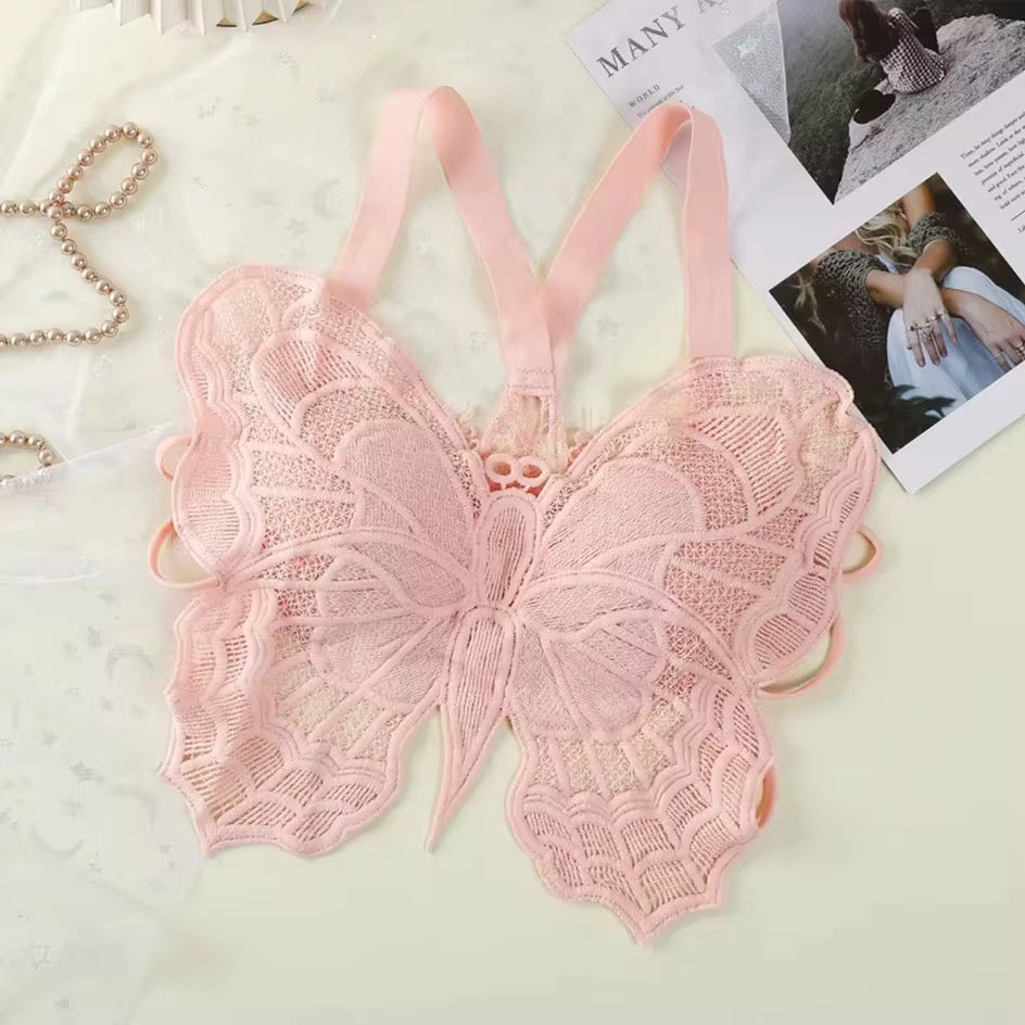Pink lace butterfly-shaped bralette on a light background