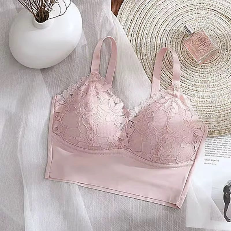 Pink bralette with lace details on a light background