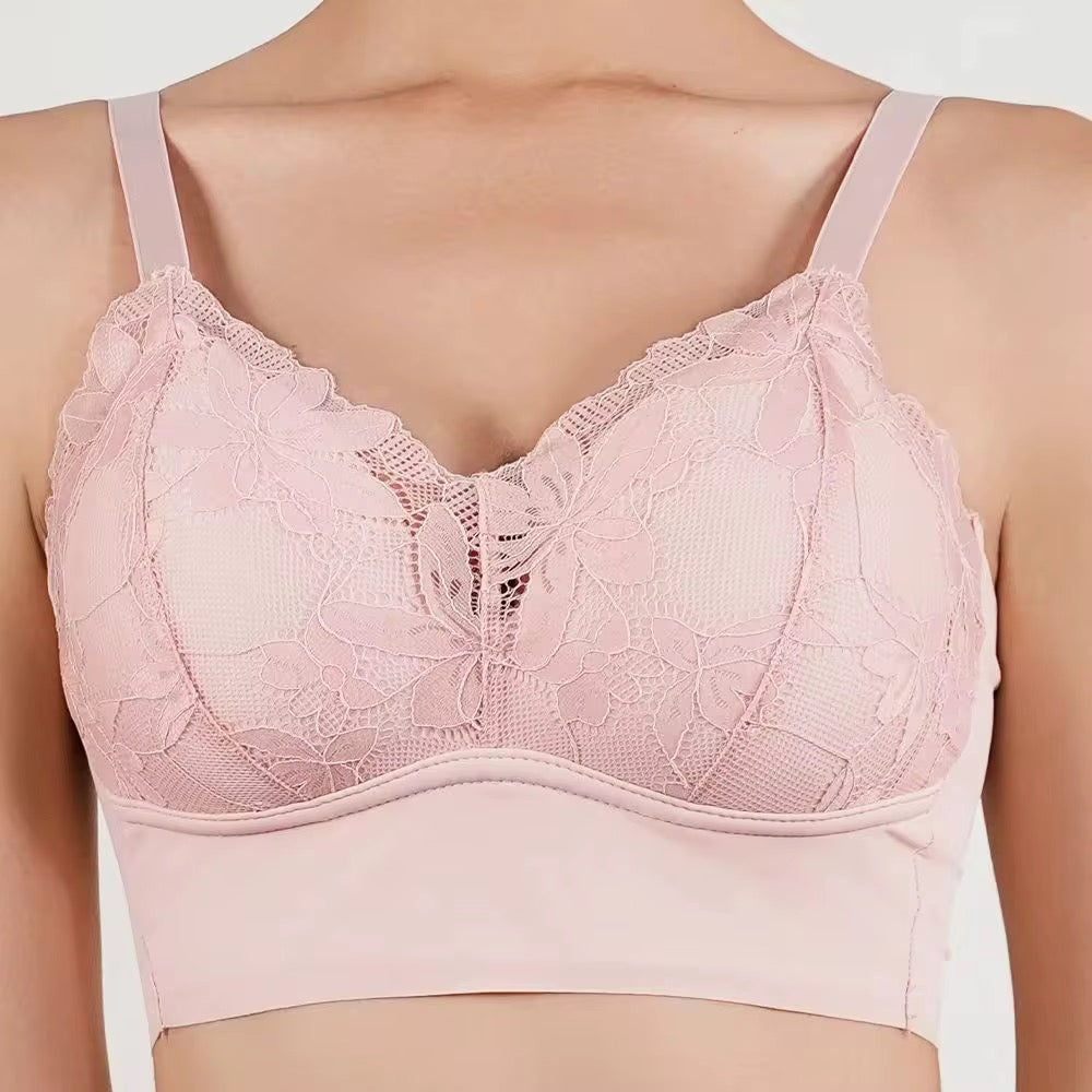 Pink lace bra on a plain background