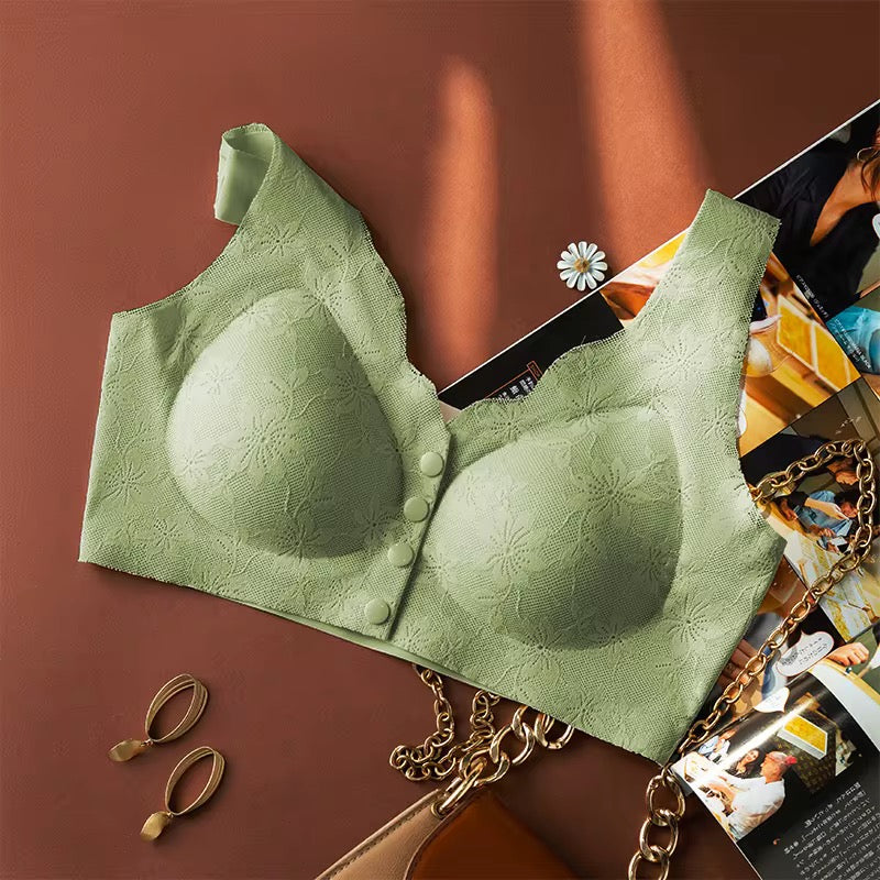 Green bra on a magazine with earrings and a handbag in the background