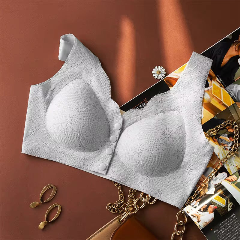 White bra with floral patterns on a magazine and gold chain background