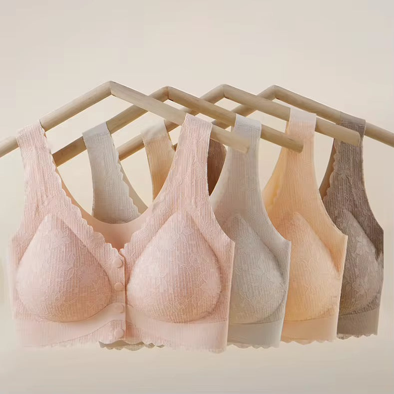 Set of six bras in various colors hanging on a rack against a light background