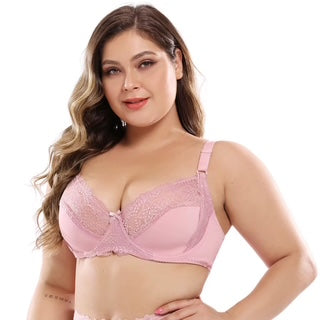 Woman wearing a pink bra against a white background