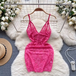 Pink lace dress on a hanger with a white fur rug and floral background