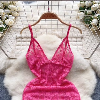 Pink lace lingerie on a hanger against a white fur background