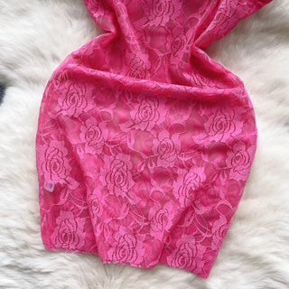 Pink lace fabric on a white fur background