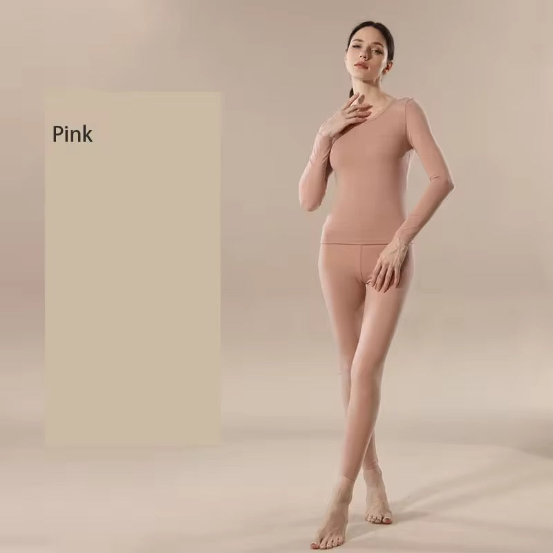 Woman wearing a pink bodysuit against a beige background