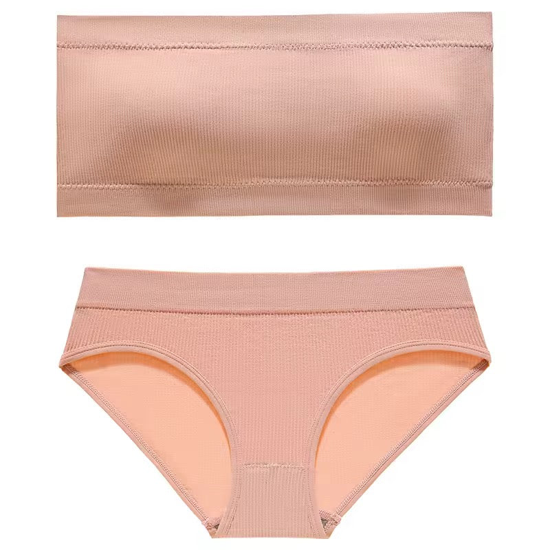 Set of peach-colored underwear on a white background