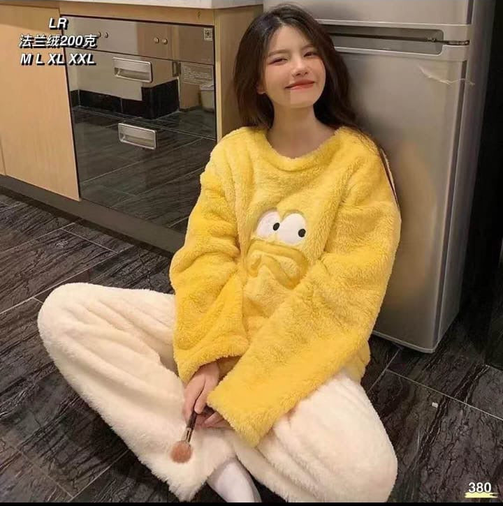 Person wearing a yellow fleece outfit sitting on the floor.
