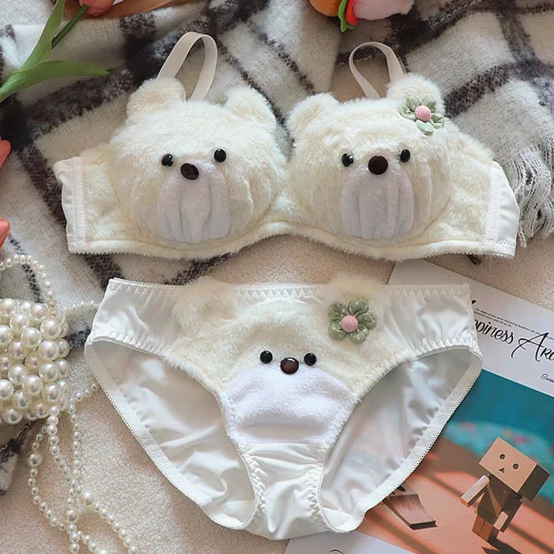 White teddy bear-themed bra and panties set on a checkered fabric background.