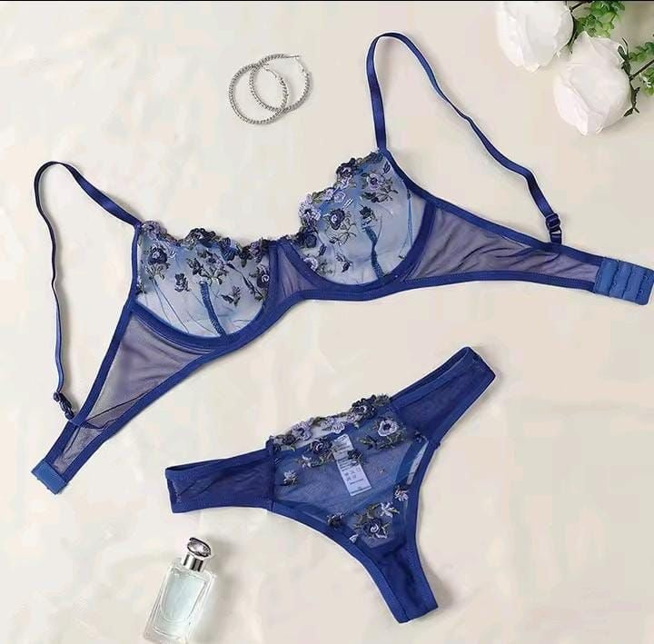 Blue lingerie set with floral embroidery on a light background