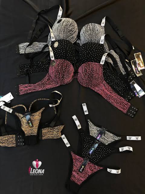 Collection of lingerie pieces with rhinestone embellishments on a black surface, featuring the LEONA brand logo.