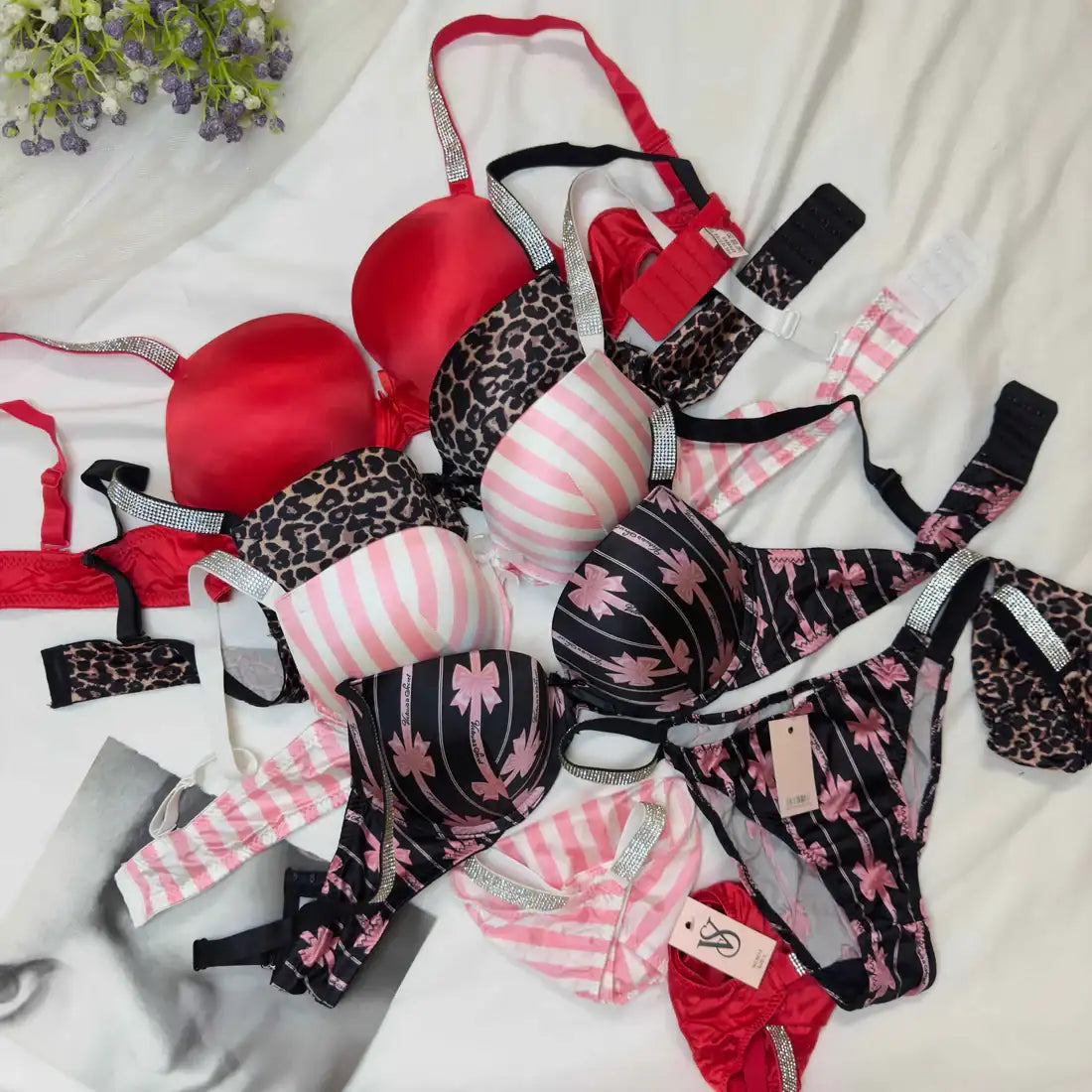 Collection of patterned lingerie on a white fabric background