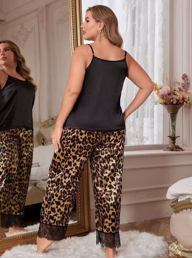 Woman wearing a black top and leopard print pants in a bedroom setting.