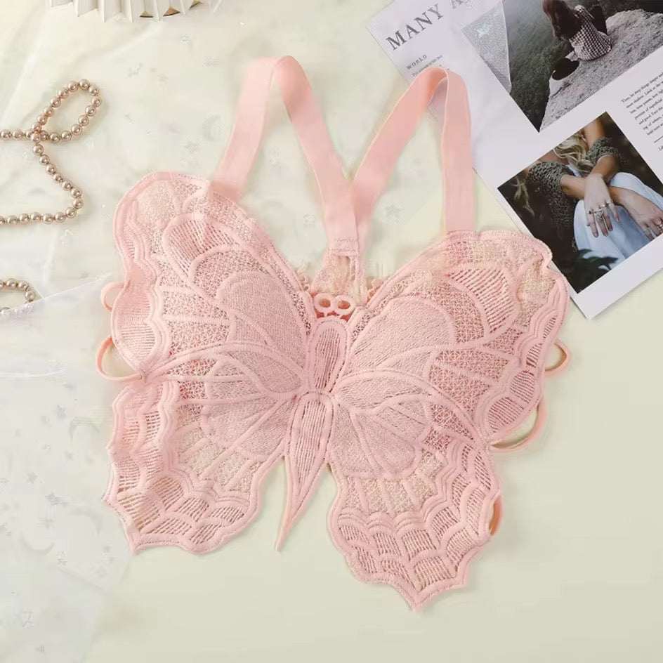 Pink lace butterfly-shaped bralette on a light background