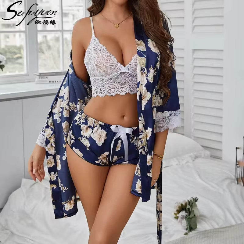 Woman wearing a white lace bra and blue floral kimono in a bedroom setting.