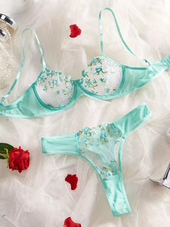 Teal lingerie set with floral embroidery on a white background