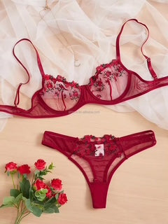Red lingerie set with floral details on a beige background