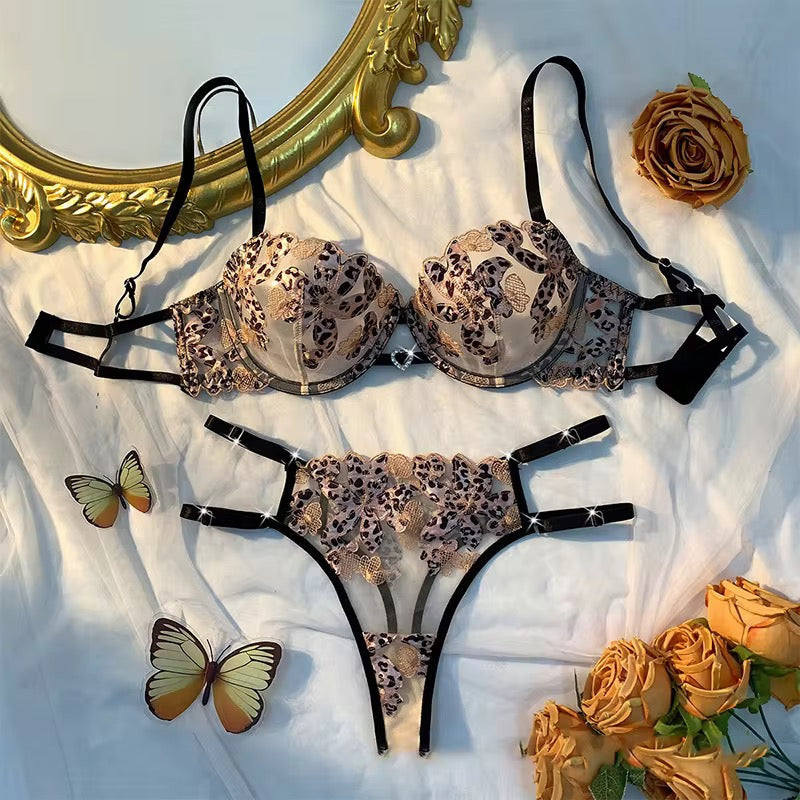 Leopard print lingerie set with flowers and a mirror on a white background