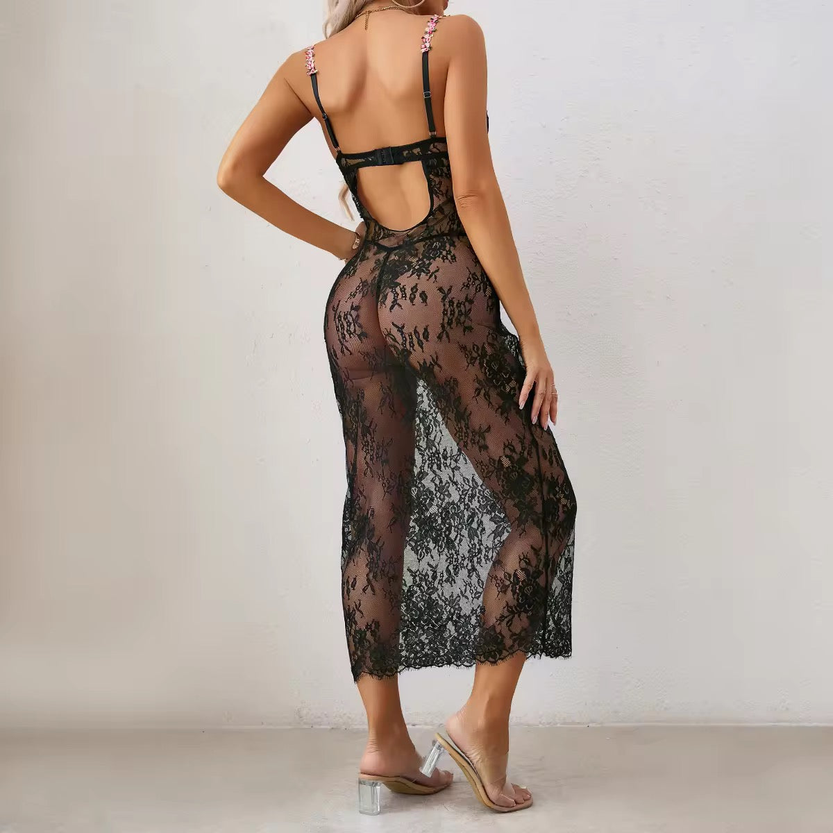 Black lace dress worn by a model against a plain background
