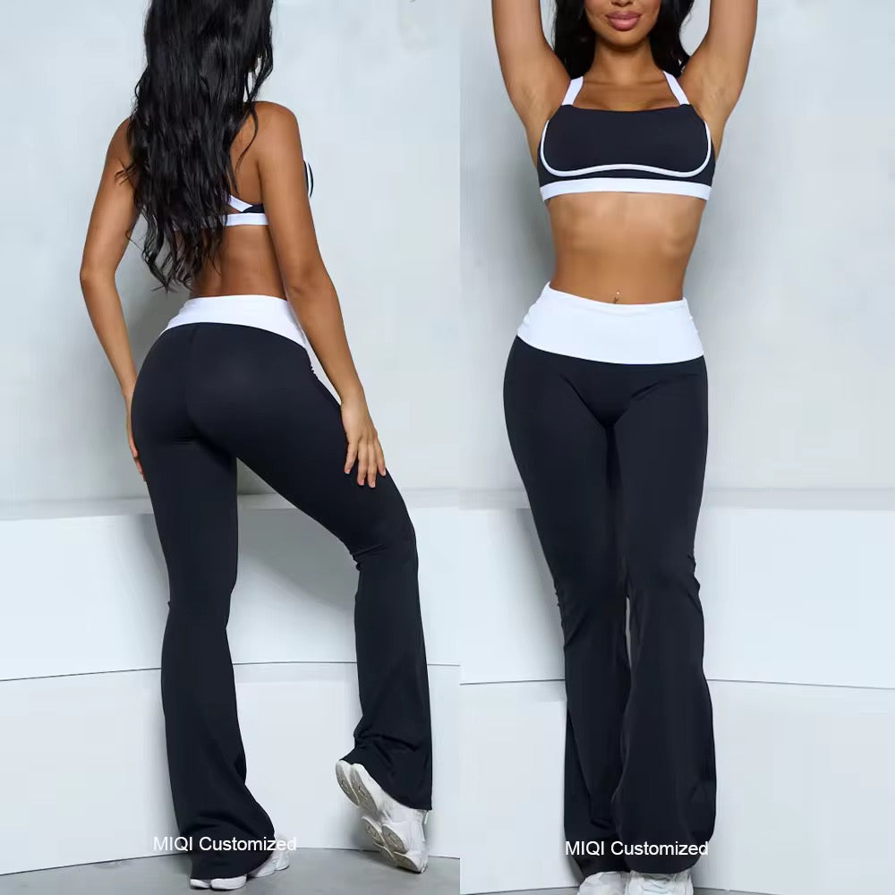 Two women wearing black and white sports bras and leggings against a white background.