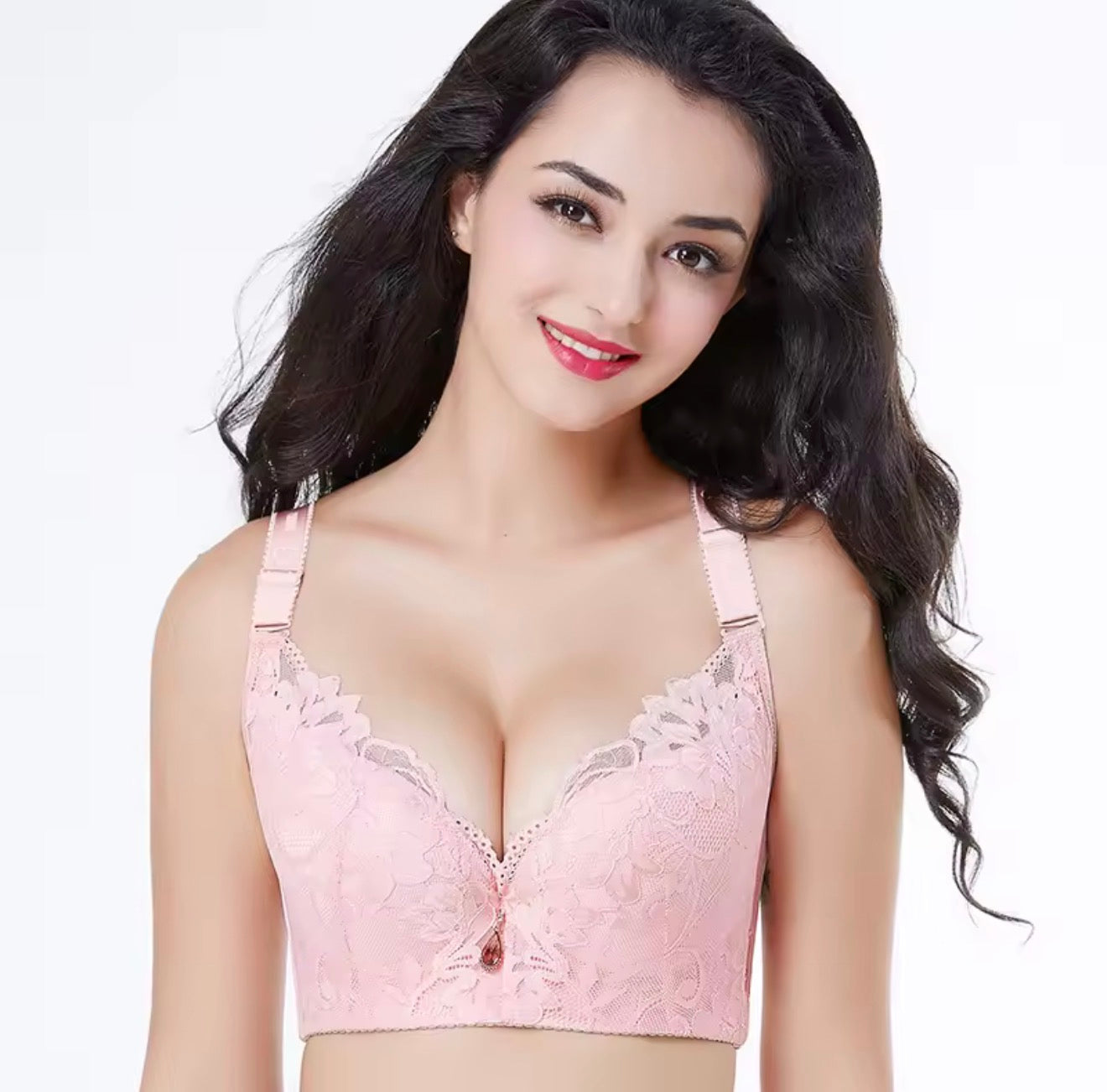 Woman wearing a pink lace bralette on a white background