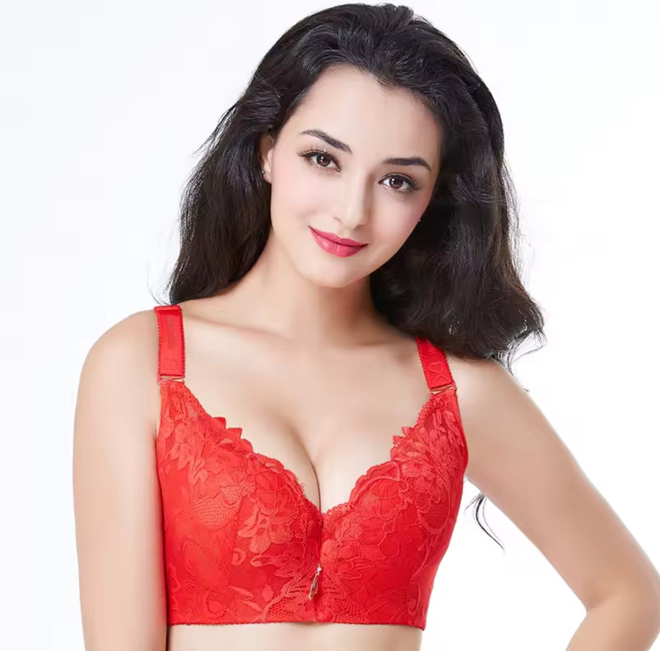 Woman wearing a red lace bra against a white background