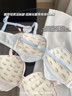 A close-up of a light beige and white bra with a delicate blue underwire and pale blue trim, layered over a matching bra with a small bow. The image includes Chinese text overlays describing the product features.