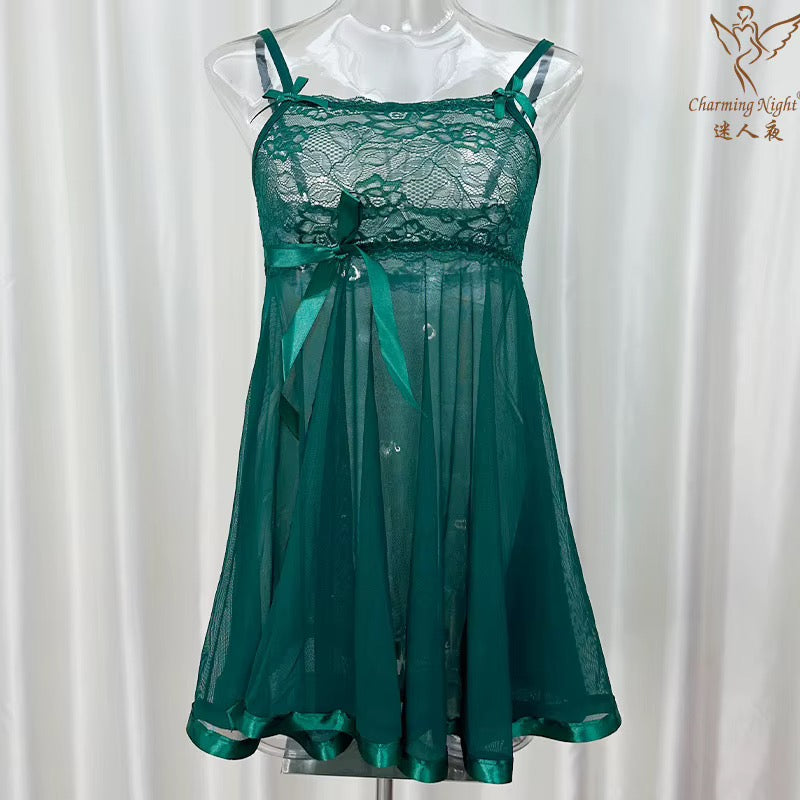 A green lace and sheer mesh babydoll chemise nightgown displayed on a clear mannequin torso against a white curtain backdrop. The chemise features a lace bodice with thin shoulder straps, a matching green satin bow at the waist, and a flowing sheer overlay skirt.