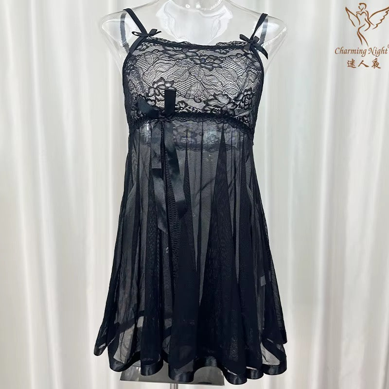 Black lace nightgown on a mannequin against a white curtain background