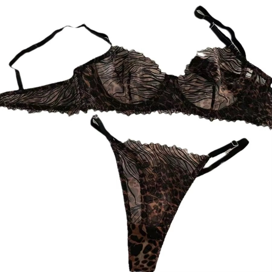 A two-piece lingerie set featuring a sheer black lace bralette with a leopard print overlay and a matching thong, displayed against a solid white background.