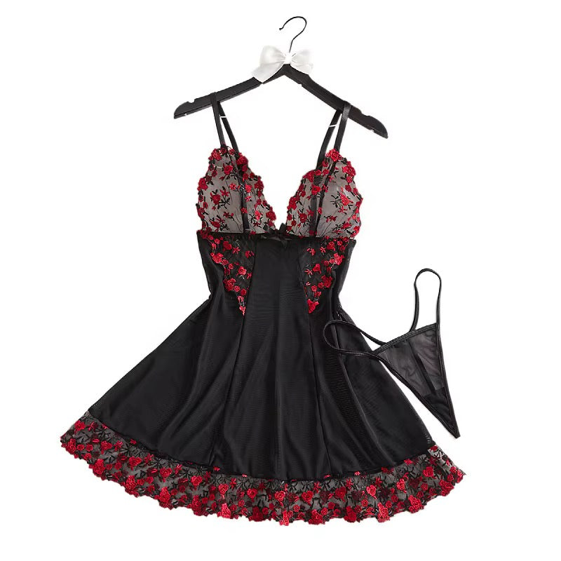 Black lingerie set with red floral embroidery, featuring a halter-style chemise dress on a hanger with a matching thong, shown against a plain white background.