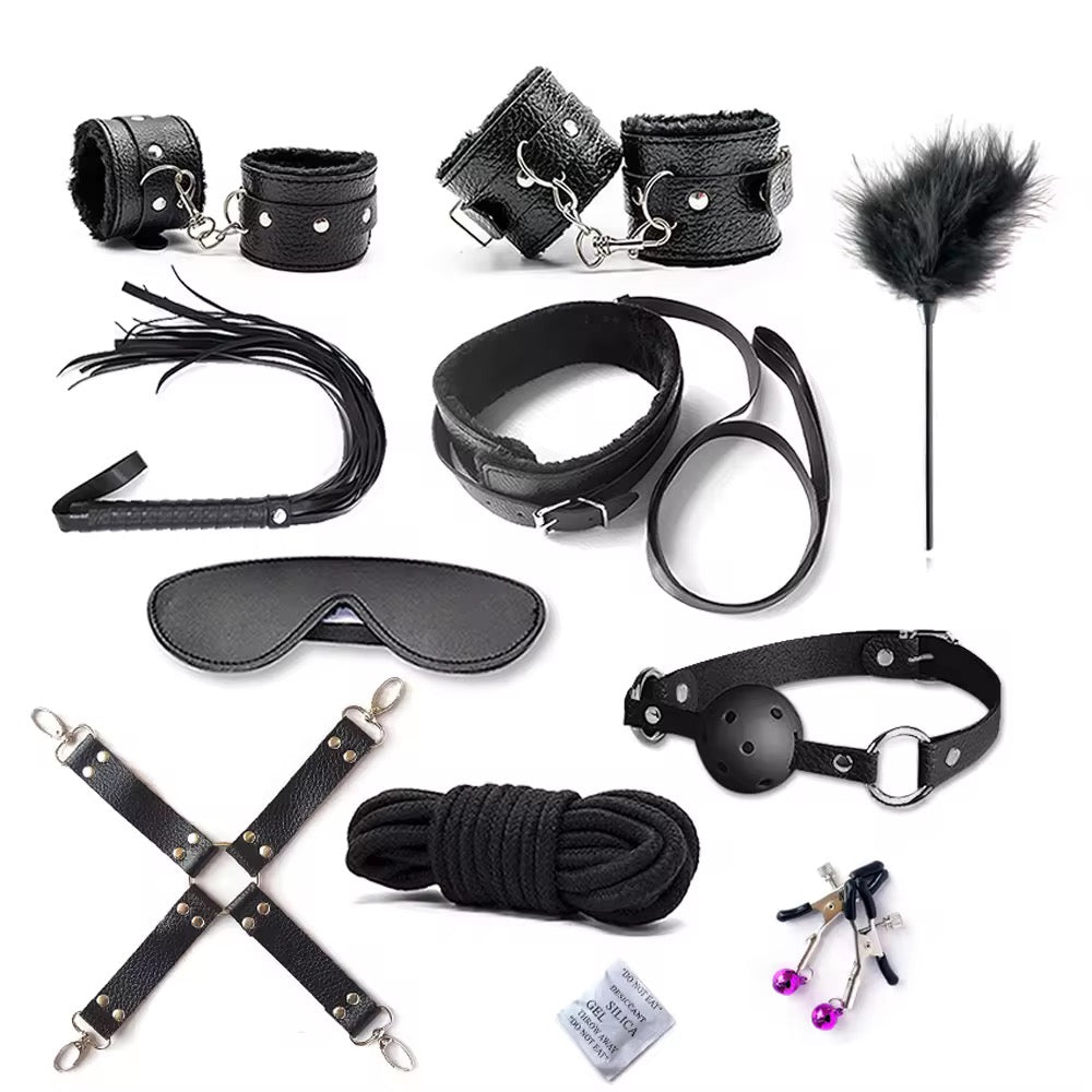 Collection of black leather bondage accessories on a white background