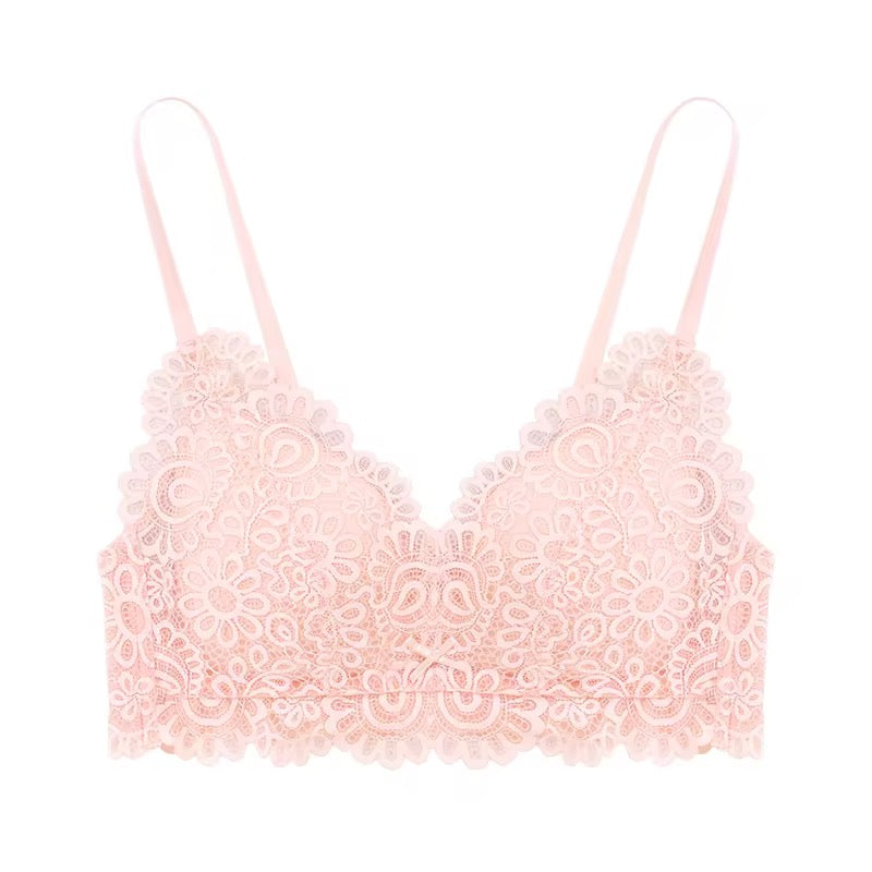 Pink lace bralette on a white background
