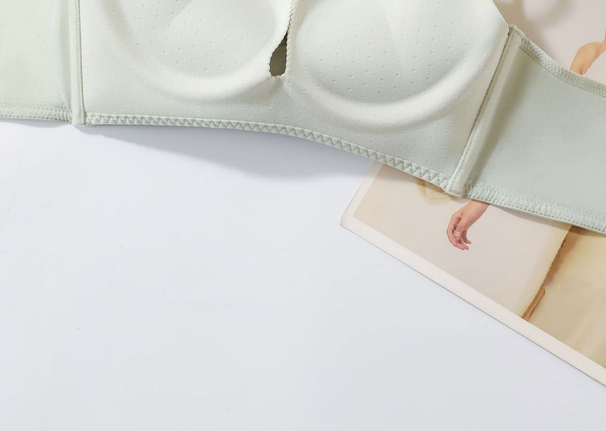 Green waist trainer on a white surface with a blurred background