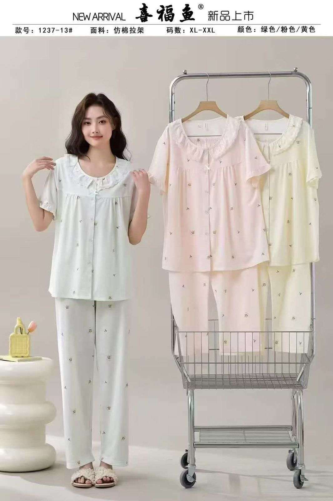 Woman standing next to a clothing rack with pajama sets on a plain background