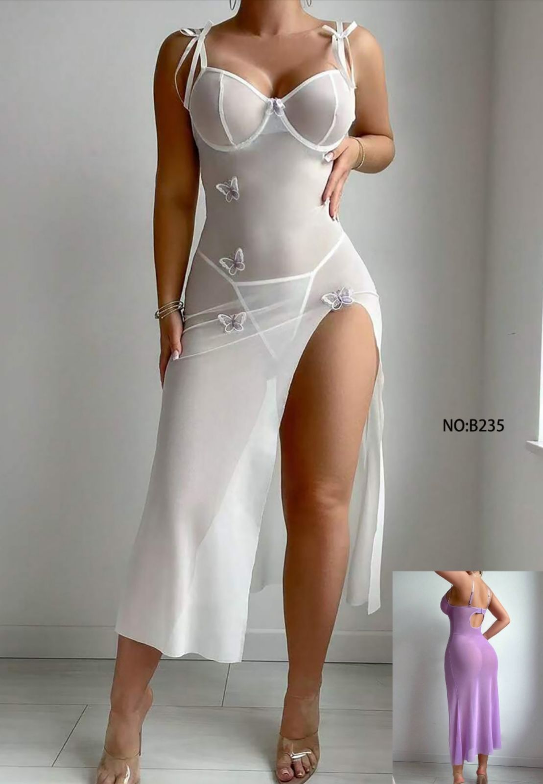 White sheer dress with butterfly details on a plain background