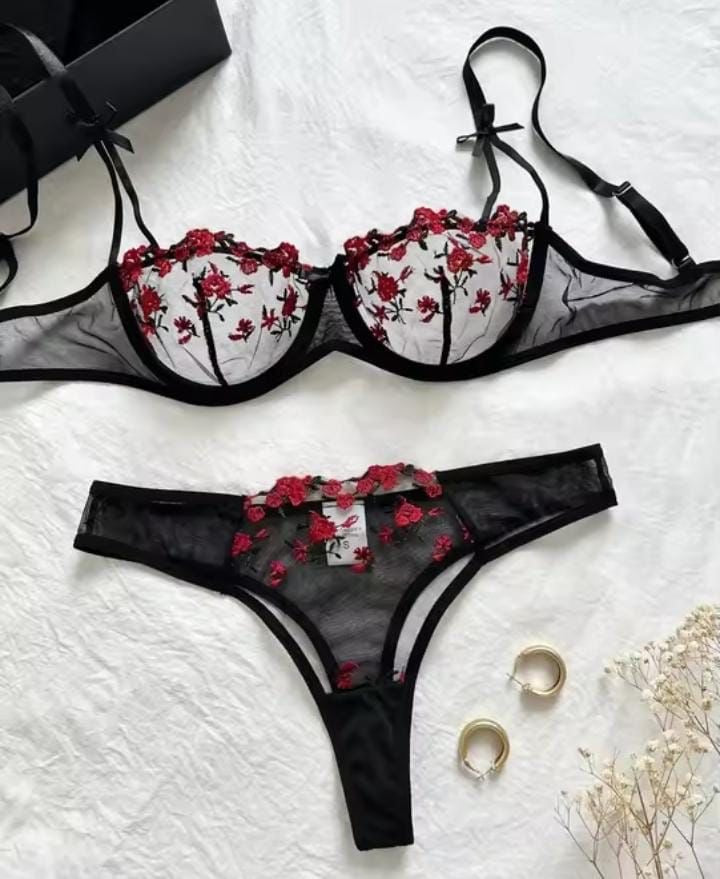 Black lingerie set with floral embroidery on a white background