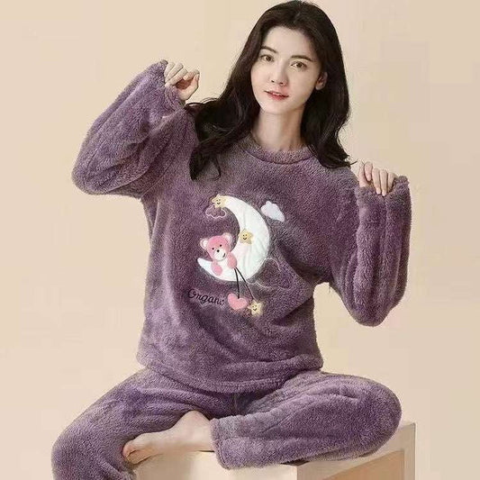 Woman wearing a purple pajama set with a cartoon design on a beige background